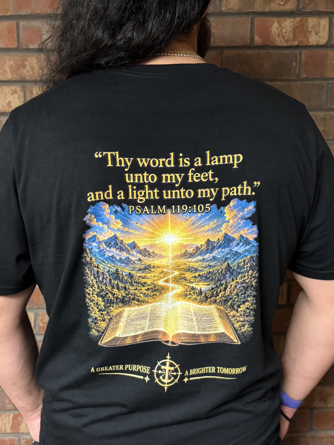 Back of the shirt with Psalm 119:105, an open Bible, mountains, and a golden path